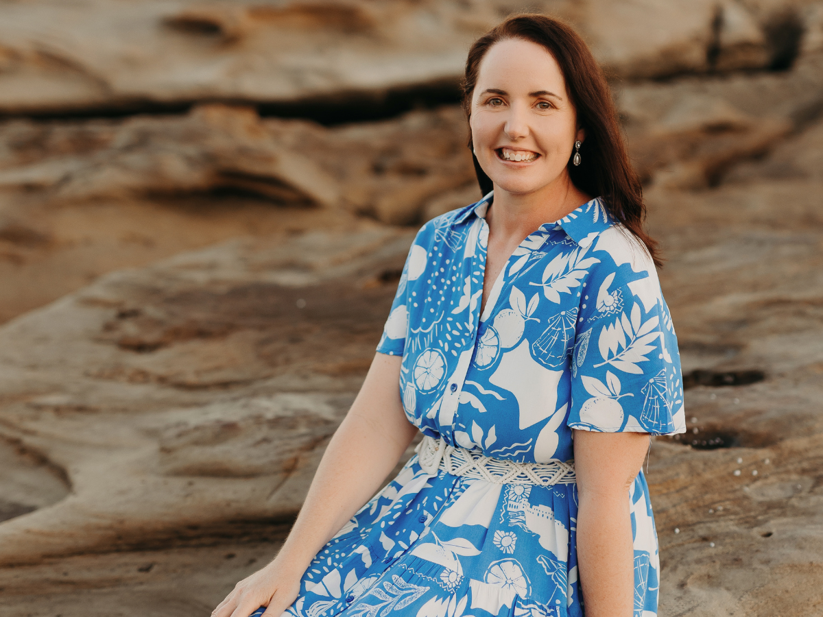 copywriting-testimonials-breezy-words Copywriter Jane Havercroft sitting on rocks at the beach